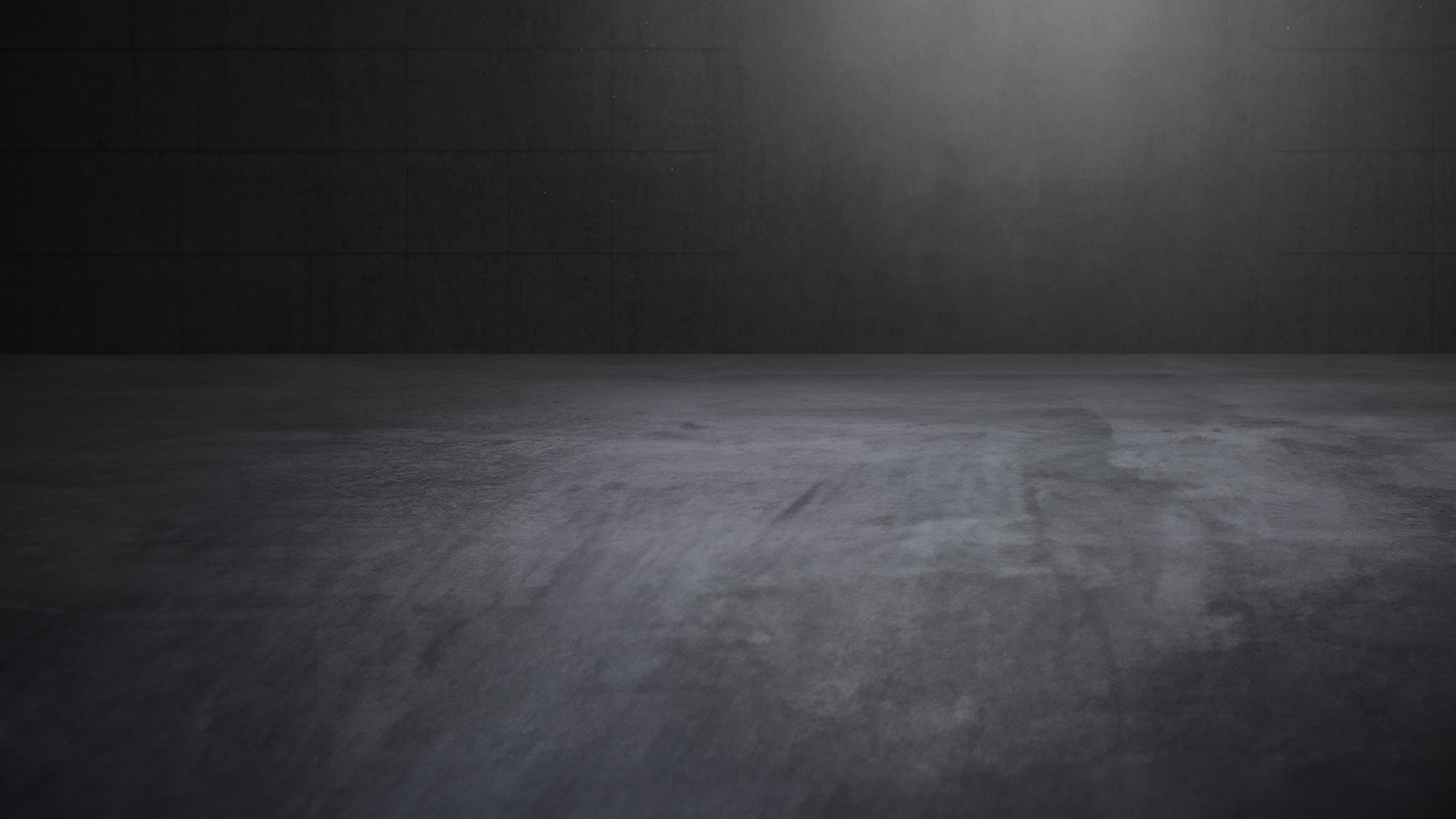 Concrete showroom with atmospheric direct light and empty space.