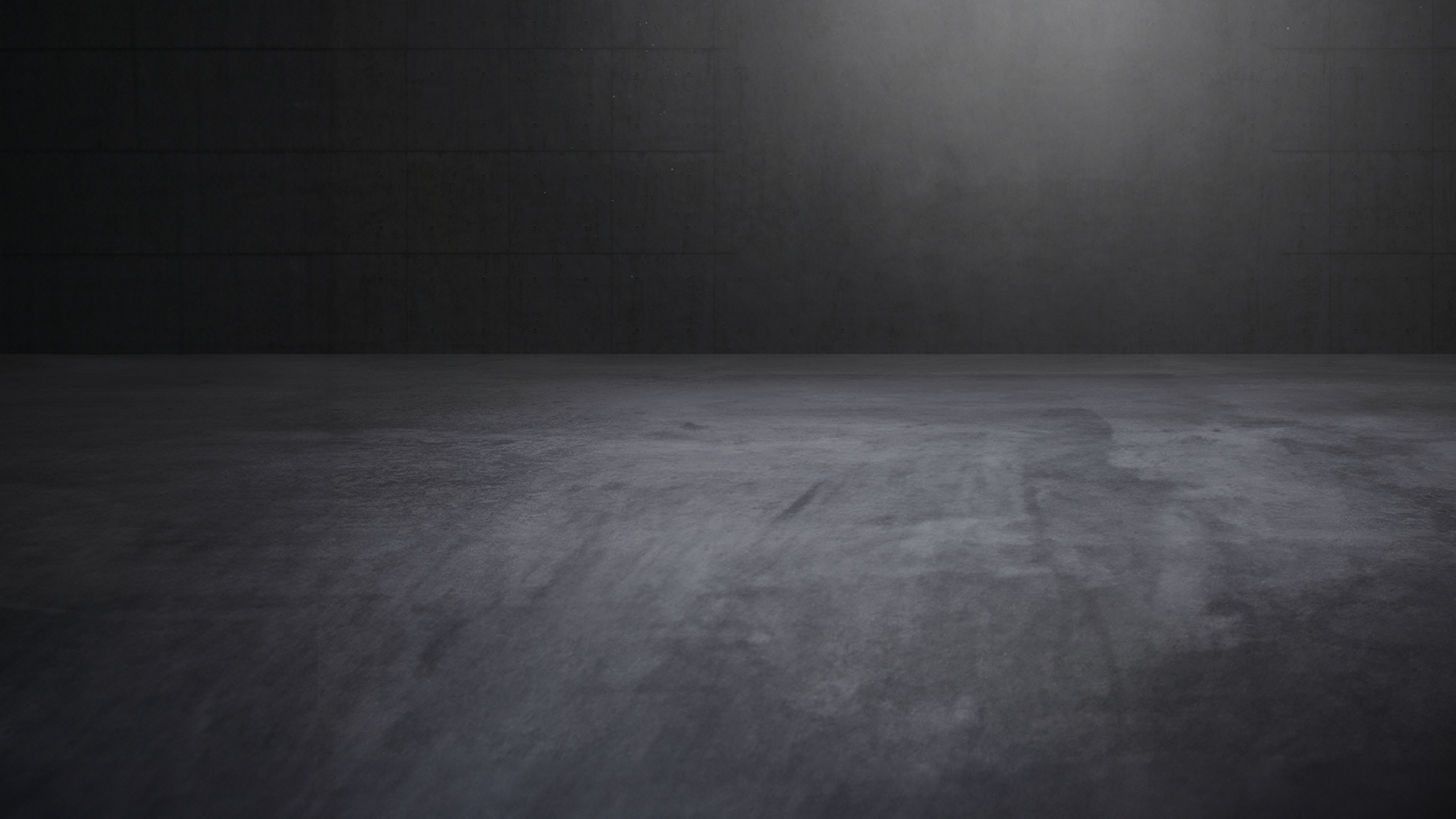 Concrete showroom with atmospheric direct light and empty space.