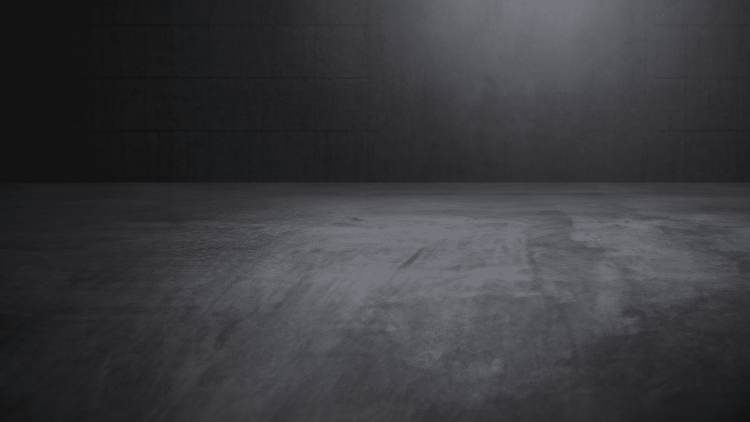 Concrete showroom with atmospheric direct light and empty space.
