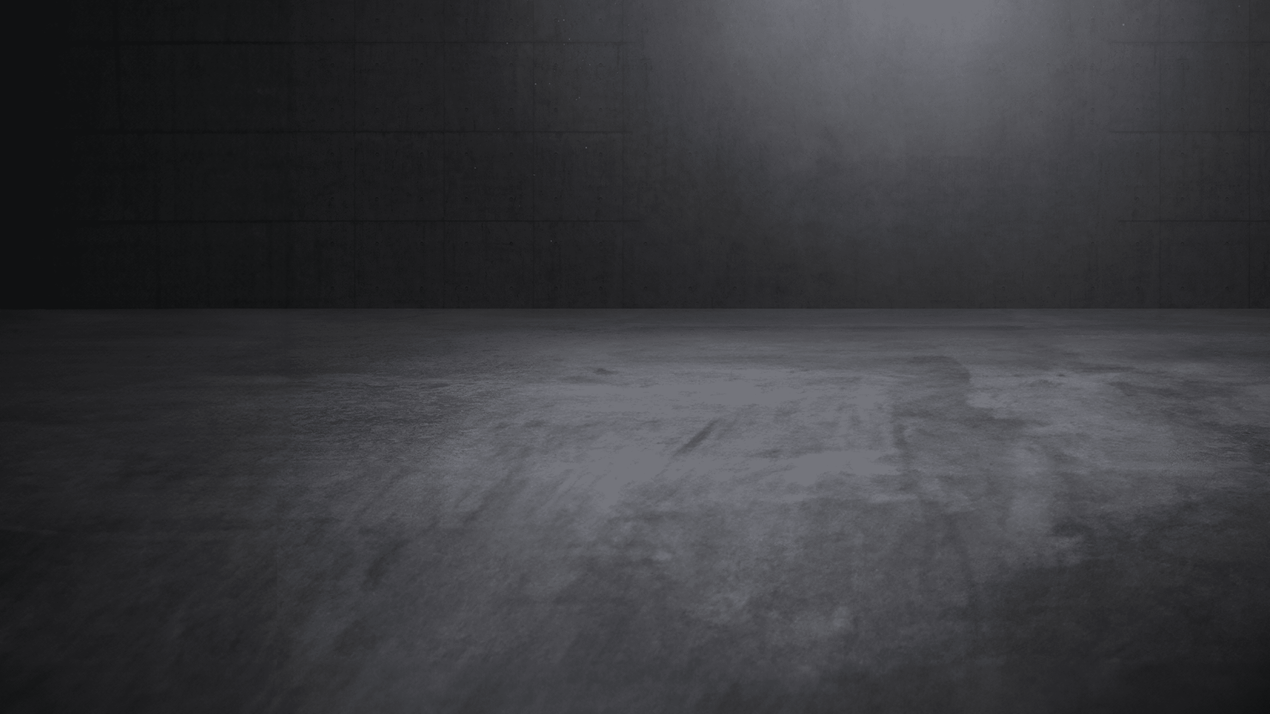 Concrete showroom with atmospheric direct light and empty space.