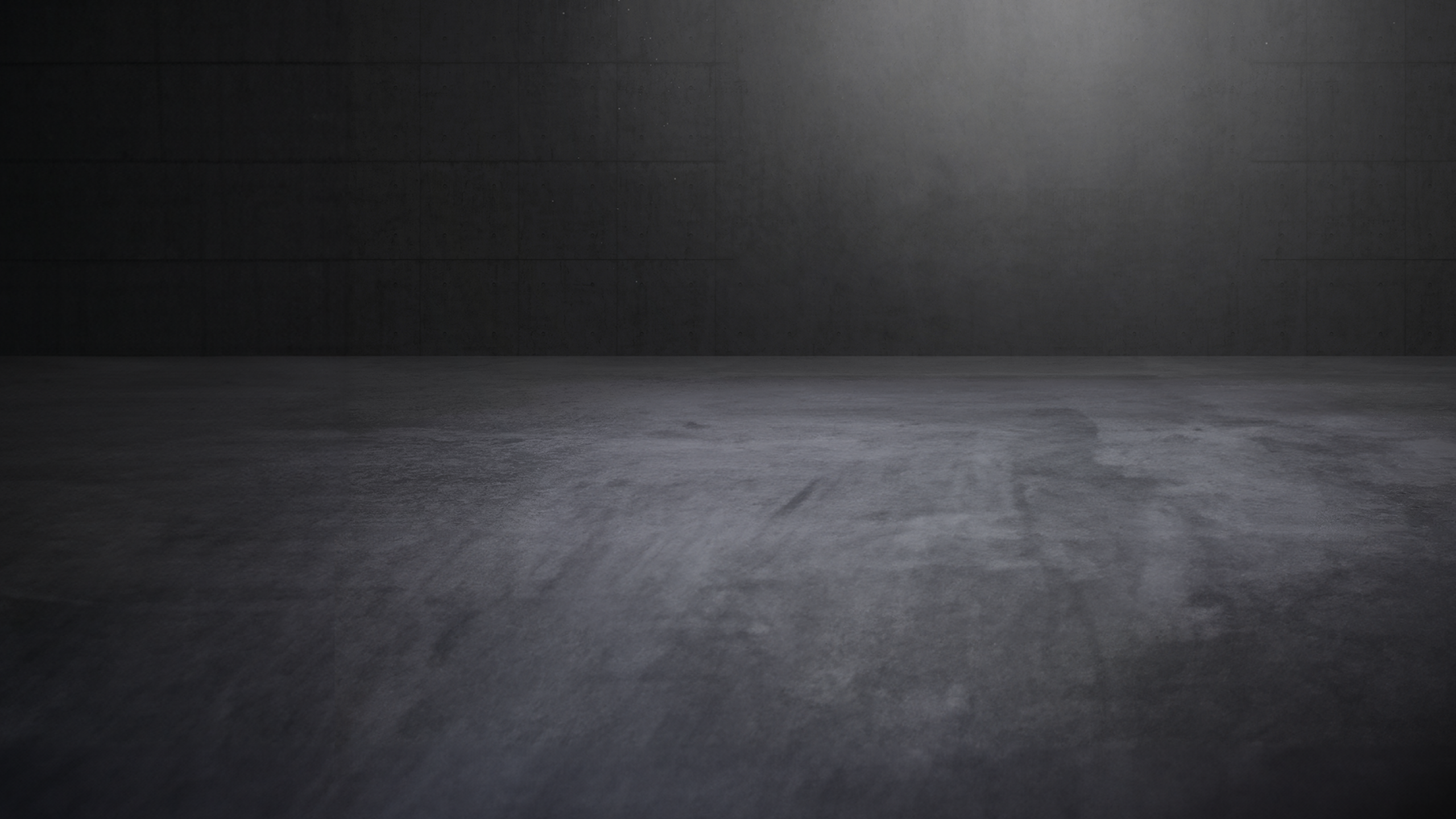 Concrete showroom with atmospheric direct light and empty space.