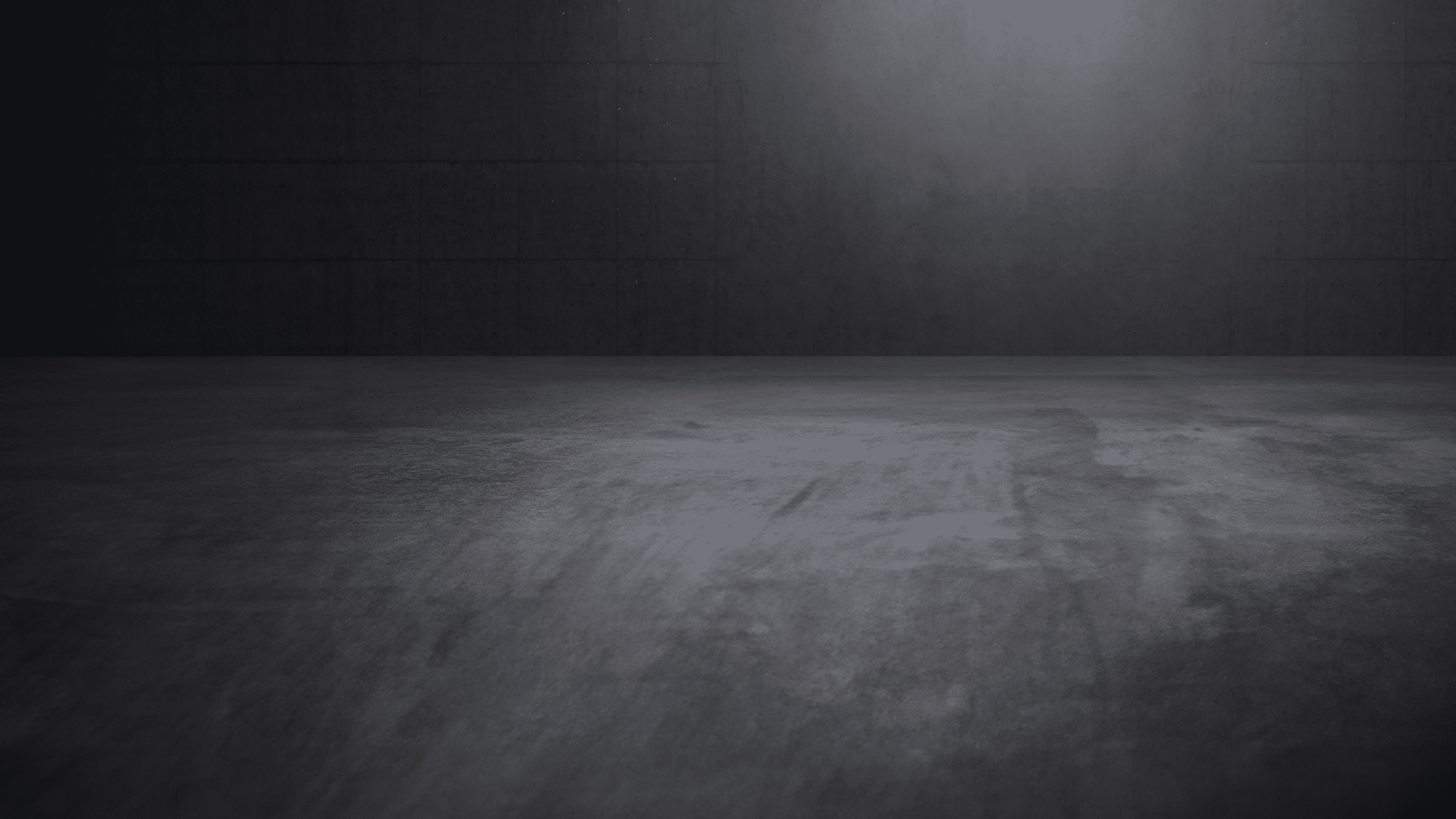 Concrete showroom with atmospheric direct light and empty space.
